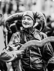 monochrome photo of a jester in a crowd