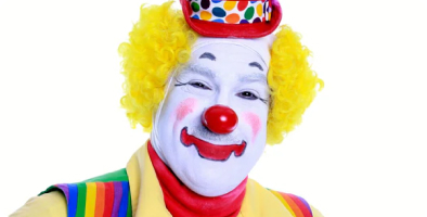Whiteface Clown in rainbow outfit
