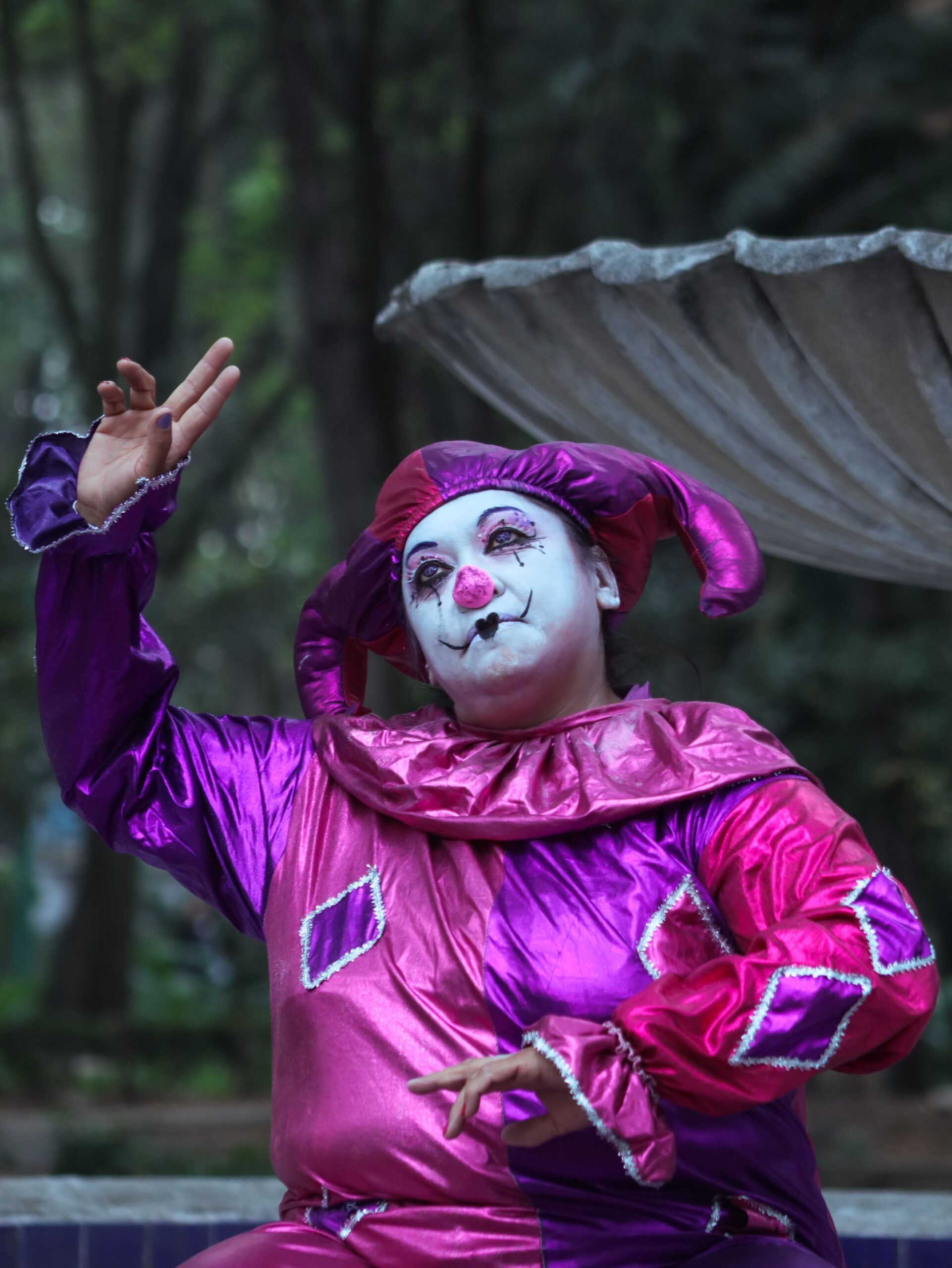 Clown in vibrant costume posing outdoors